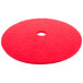 A red Scrubble buffing pad for a floor machine with a hole in the middle.