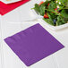 A plate of salad with a purple Creative Converting luncheon napkin.