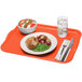 A Cambro rectangular citrus orange fiberglass tray with a plate of food and a bowl of salad on it.