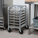 A Channel HT307 sheet pan rack filled with metal trays on wheels.