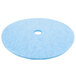 A blue Scrubble burnishing pad with a white center.
