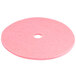 A pink Scrubble burnishing pad with a hole in the middle.