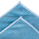 A blue Unger SmartColor medium-duty microfiber towel with white edges.