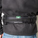 A man wearing a black Unger ErgoTec belt with a green buckle.