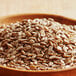 A wooden bowl of raw sunflower seeds.