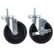 A pair of Master-Bilt stem casters with black rubber wheels.