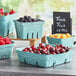 Blue rectangular 2 Qt. green molded pulp produce baskets filled with a variety of fruit.