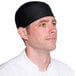 A man wearing a black Headsweats chef skull cap.