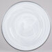 A white Charge It by Jay glass charger plate with a silver rim and a swirly design.
