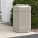 A beige hexagonal Commercial Zone outdoor trash can with an open top.