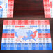 Hoffmaster U.S. State Facts placemats with a map of the United States on a table.