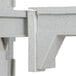 A close up of a white plastic Cambro Camshelving connector corner.