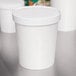 A white Choice paper container with a lid on top.