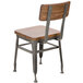 A BFM Seating Lincoln wooden chair with metal legs and back.