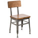 A BFM Seating Lincoln side chair with a wooden seat and back and metal legs.