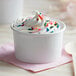 A white Choice paper cup filled with ice cream and sprinkles.