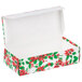 A white candy box with red and green poinsettias on it and an open lid.