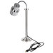 A stainless steel freestanding single bulb heat lamp with a black cord.