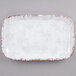 A white rectangular tray with brown speckled edges.