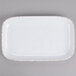 A white rectangular platter with brown specks on the edges.