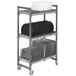 A white metal Cambro Elements drying rack cart with three tiers holding plates.