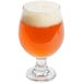 A Libbey stackable tulip glass filled with foamy beer.