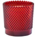 A Sterno rouge glass lamp with a candle inside.