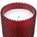 A Sterno Rouge flameless candle in a red hobnail glass container.