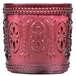 A Sterno Amelia rose flameless candle in a red glass holder with a pattern.