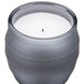 A Sterno flameless wax filled glass lamp with a gray exterior and a white flame inside.