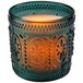 A Sterno teal flameless candle in a glass holder with a decorative design on it.