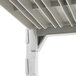 A close-up of a white plastic shelf on a white metal structure.