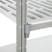 A close-up of a Cambro Camshelving® stationary shelf with a gray vented shelf.
