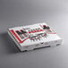 A white corrugated pizza box with red and black graphics on it.