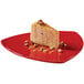 A slice of cheesecake on a red GET triangular melamine plate.