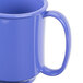 A close up of a peacock blue plastic mug with a handle.