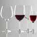 A group of Stolzle Classic Burgundy wine glasses filled with red wine.