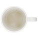 An ivory GET Tritan mug with a small amount of liquid in it.
