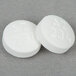 Two white Medique APAP Acetaminophen tablets with the number 24 on them.