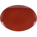 A red oval melamine platter with speckled black surfaces.