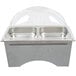 A silver Sterno chafing dish with clear dome covers on a white counter.