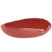 A red oval melamine bowl on a white background.