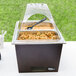A Sterno Copper Vein chafing dish with a clear lid and food inside.