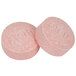 Two pink Medique headache and sinus pills with writing on them.