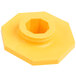 A yellow plastic hexagon nut with a hole in it.