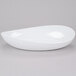 A close up of a white oval shaped GET Osslo melamine bowl.