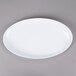 A white oval GET Osslo melamine platter with a white rim.
