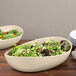 Two bowls of salad in GET Manila melamine bowls on a table.