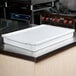 A white fiberglass MFG Tray dough proofing box on a counter.