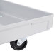 A gray fiberglass dolly for MFG Tray pizza dough boxes with wheels and a handle.
